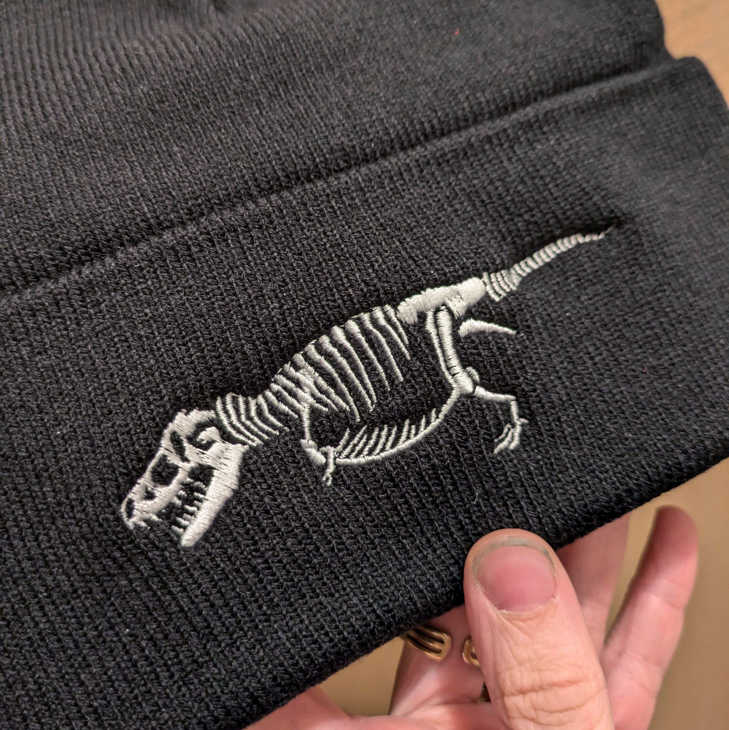 Black Beanie with Embroidered T-rex Skeleton